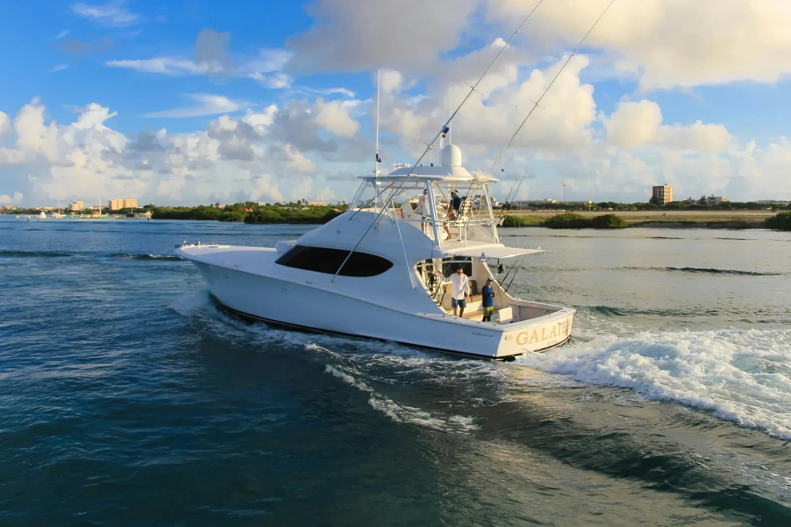 A sport-fishing boat running through a coastal channel